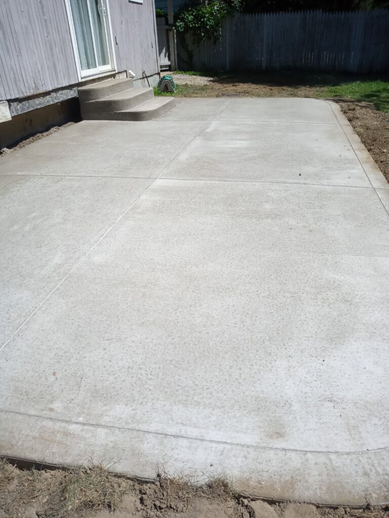 New concrete patio pad with poured steps