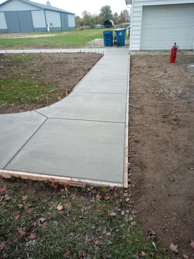 New concrete sidewalk to garage